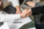 close up two business people shaking hands